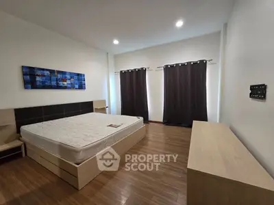 Spacious bedroom with modern decor and natural light