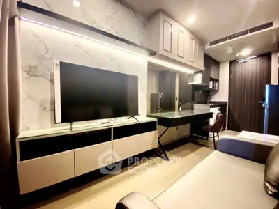 Modern living room with sleek TV setup and stylish furniture in a contemporary apartment.