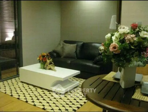Stylish living room with modern decor and elegant floral arrangements.