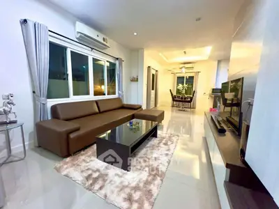 Spacious modern living room with sleek furniture and ambient lighting