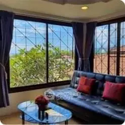 Charming living room with large windows and cozy seating area