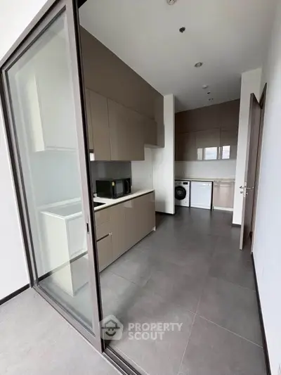 Modern kitchen with sleek cabinetry and appliances in a stylish apartment