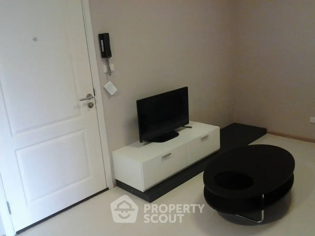 Modern minimalist living room with sleek TV stand and stylish coffee table.