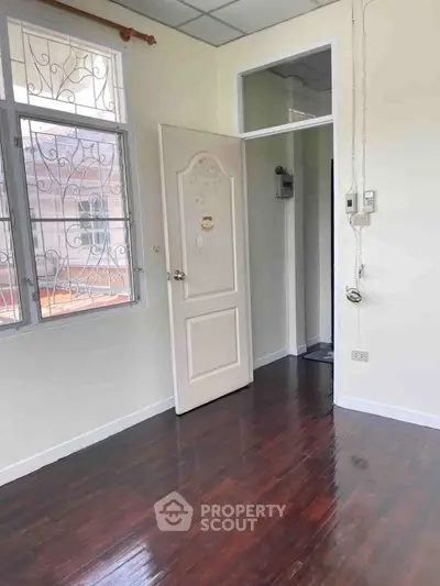 Charming interior with wooden floors and natural light, perfect for cozy living.