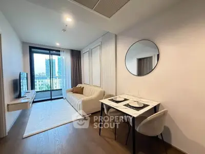 Modern living room with elegant decor and balcony view in a stylish apartment.