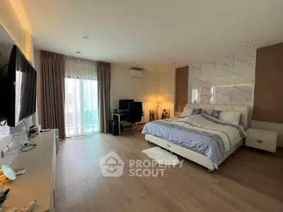 Spacious modern bedroom with elegant decor and natural light