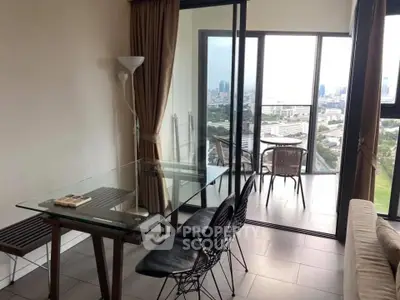 Modern living room with glass dining table and balcony offering stunning city views.