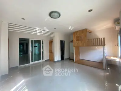 Spacious modern living room with unique wooden loft and ample natural light
