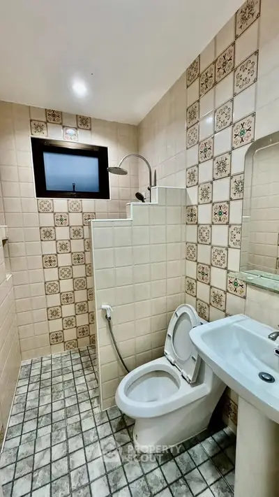 Charming vintage bathroom with patterned tiles and modern fixtures