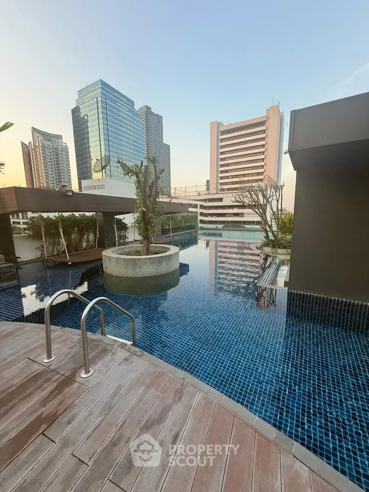 Luxurious rooftop pool with stunning cityscape views in a modern high-rise building.