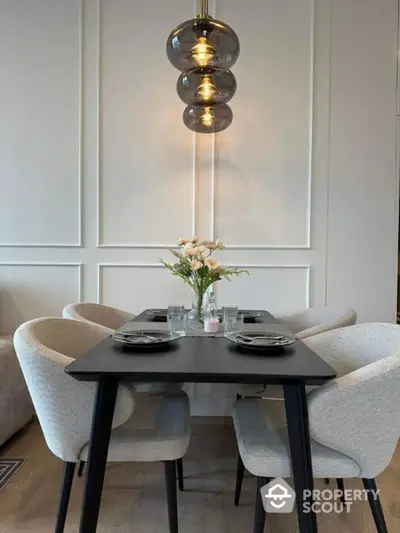 Elegant dining area with modern chandelier and stylish seating