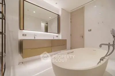 Luxurious modern bathroom with elegant fixtures and a freestanding bathtub.