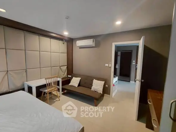 Modern bedroom with stylish decor and cozy seating area