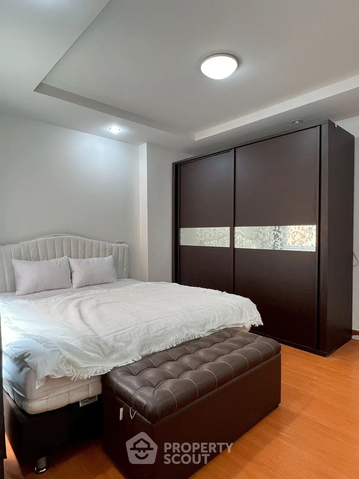 Spacious bedroom with elegant decor and ample storage space