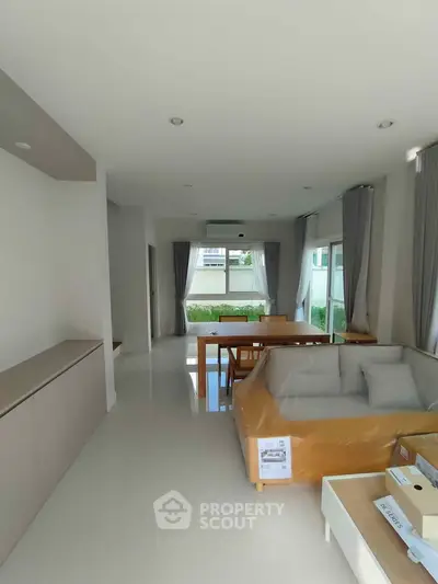 Modern living room with natural light and minimalist furniture