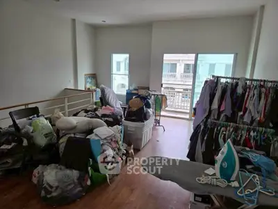 Spacious room with balcony, ideal for storage or creative space, featuring ample natural light and hardwood floors.
