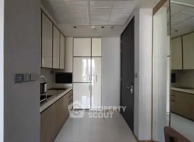 Modern kitchen with sleek cabinetry and built-in appliances in a contemporary apartment.