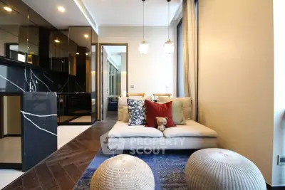 Modern living room with cozy sofa, stylish decor, and elegant lighting