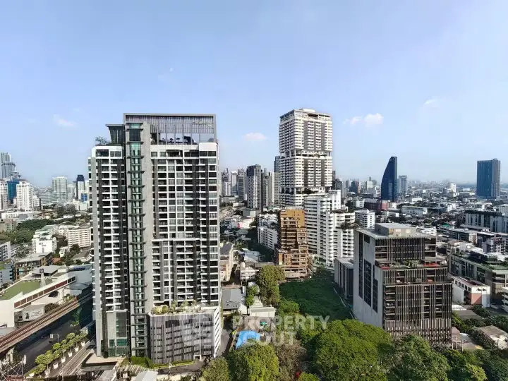 Stunning cityscape view showcasing modern high-rise buildings and lush greenery in a vibrant urban setting.