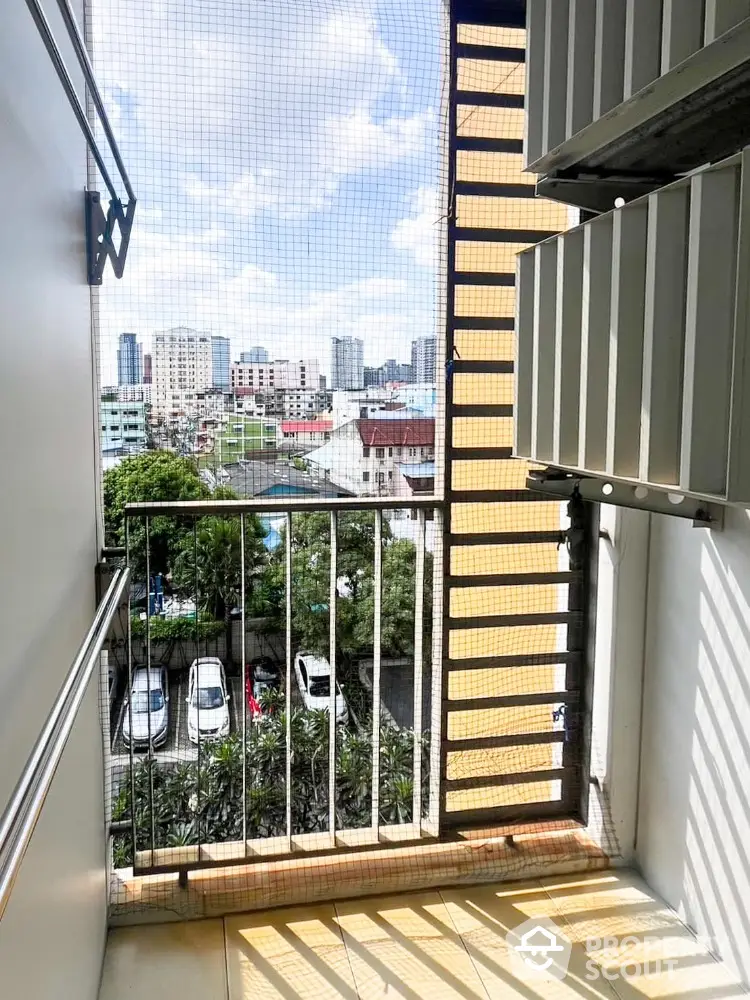 Charming urban balcony with city skyline view, perfect for relaxation and enjoying the outdoors.