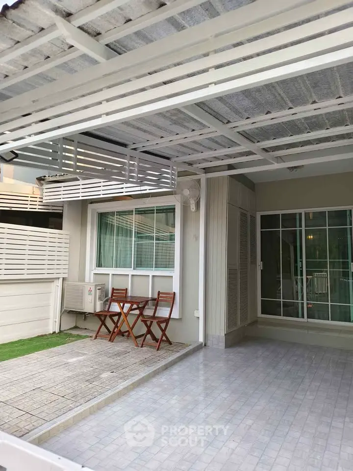 Charming outdoor patio area with seating, perfect for relaxation and entertaining in a modern home setting.