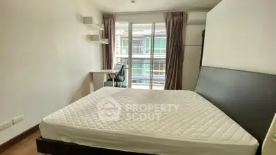 Modern bedroom with balcony view and sleek furnishings