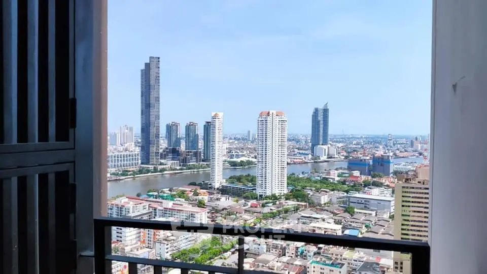 Stunning cityscape view from high-rise balcony overlooking river and skyline.