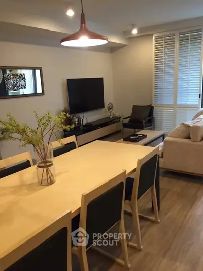 Modern living room with stylish dining area and cozy seating, perfect for entertaining guests.