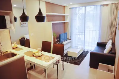 Modern living room with open kitchen, stylish lighting, and balcony view.