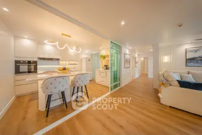 Luxurious open-plan kitchen and living room with modern decor and elegant lighting.