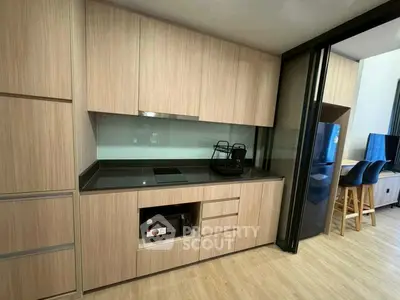 Modern kitchen with sleek cabinetry and breakfast bar seating