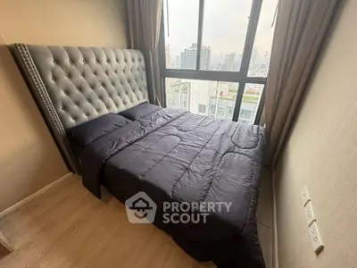 Cozy bedroom with city view and elegant tufted headboard