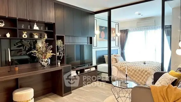 Modern living room with stylish decor and view into cozy bedroom