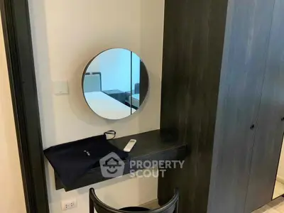 Modern bedroom with sleek vanity and mirror, featuring contemporary design and elegant storage solutions.