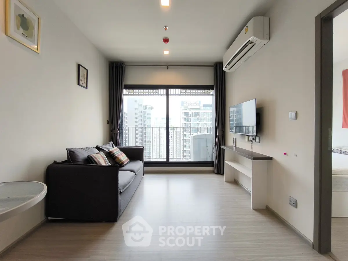 Modern living room with balcony view in high-rise apartment
