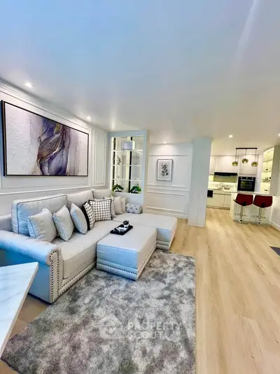 Luxurious open-plan living room with modern kitchen and elegant decor