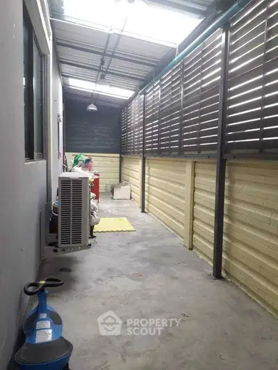 Spacious covered outdoor storage area with ample natural light and secure fencing.