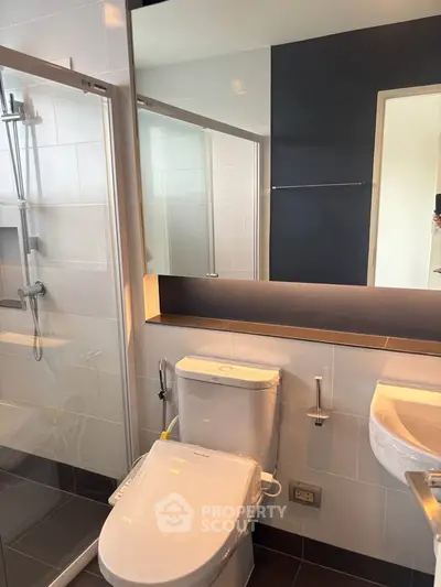 Modern bathroom with sleek fixtures and glass shower enclosure