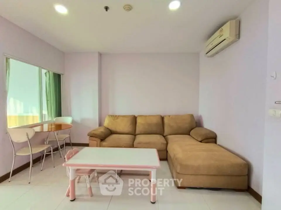 Cozy living room with beige sectional sofa and air conditioning