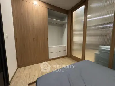 Modern bedroom with built-in wooden wardrobe and cozy ambiance