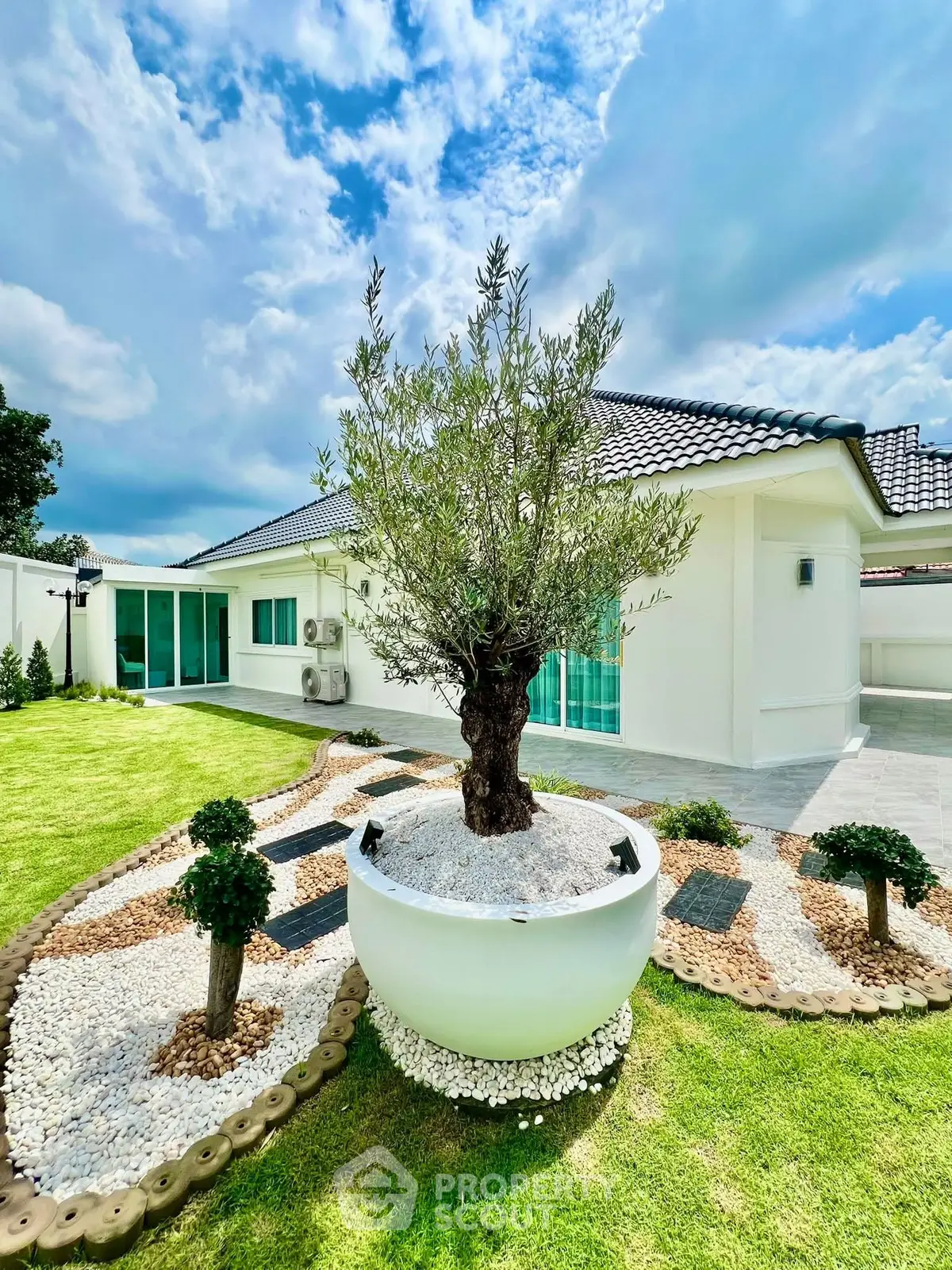 Stunning modern home with lush garden and elegant exterior design.