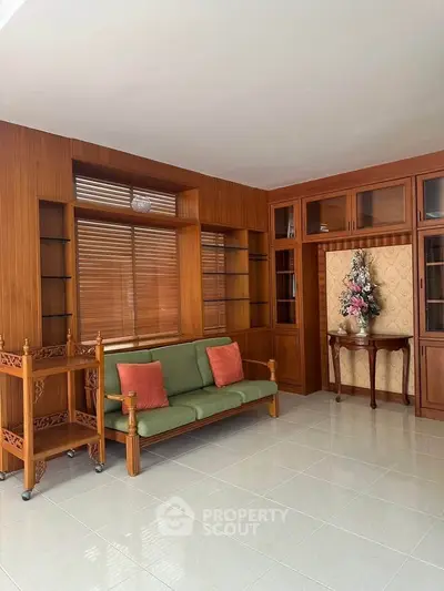 Spacious living room with wooden accents and elegant furniture, perfect for relaxation and entertaining.
