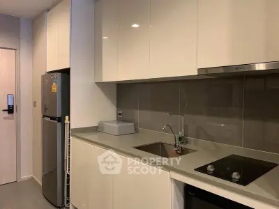 Modern kitchen with sleek cabinetry and built-in appliances in a stylish apartment.