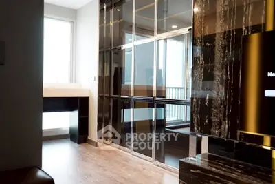 Luxurious modern living room with sleek black marble accents and large windows.