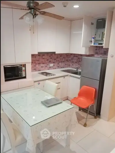 Charming kitchen with modern appliances and cozy dining area in a compact layout.