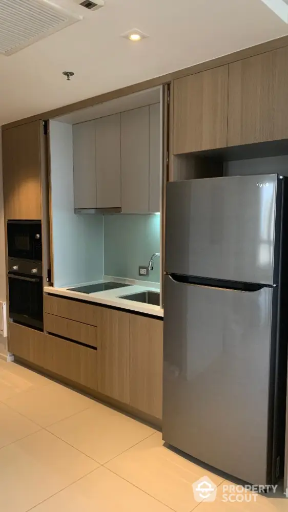 Modern kitchen with sleek appliances and wooden cabinetry