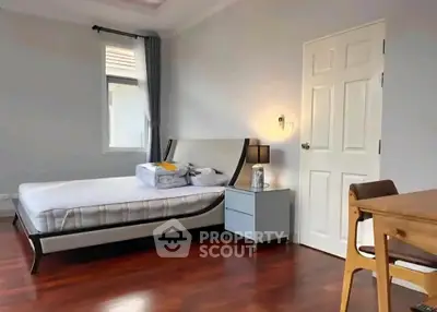 Spacious bedroom with modern furniture and natural light