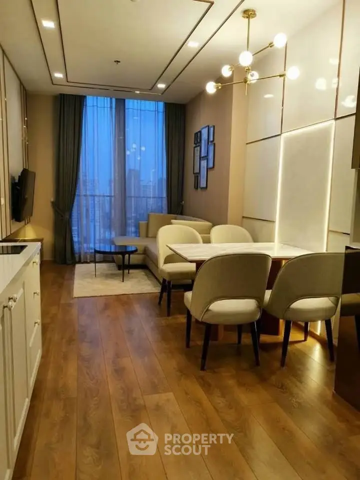 Luxurious modern living room with elegant dining area and city view, featuring chic lighting and wooden flooring.
