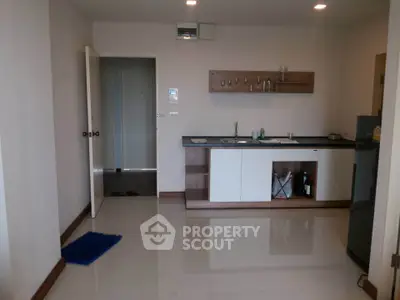 Modern kitchen with sleek cabinetry and open layout in a stylish apartment.