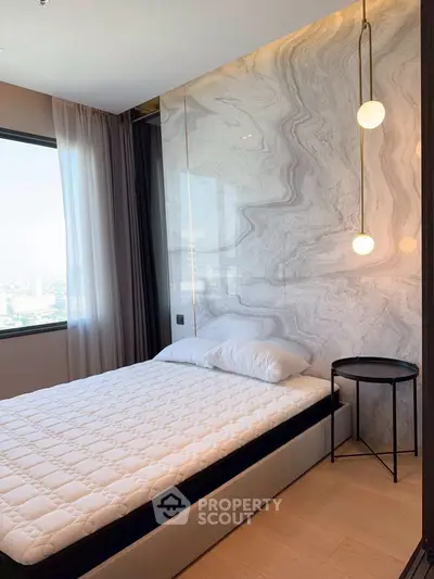 Luxurious bedroom with marble accent wall and modern lighting